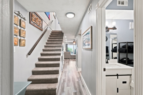 Step into your inviting entryway with modern coastal charm, featuring warm wood accents and stylish decor welcoming you home.