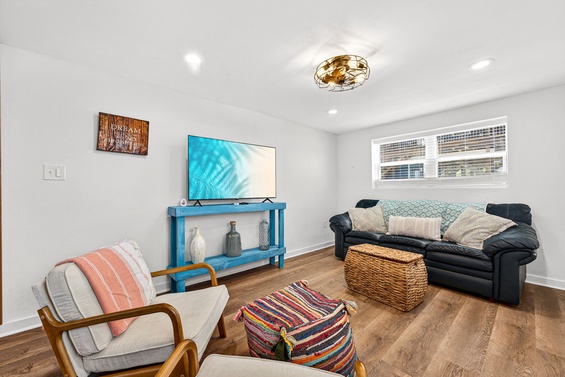 Settle into your cozy living room where natural light fills the space, inviting you to unwind on plush seating after a day of adventure.