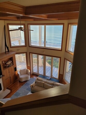 Step into your coastal sanctuary. Soaring windows frame endless ocean views, while the open living space invites you to unwind and soak in the sea breeze from your private deck.