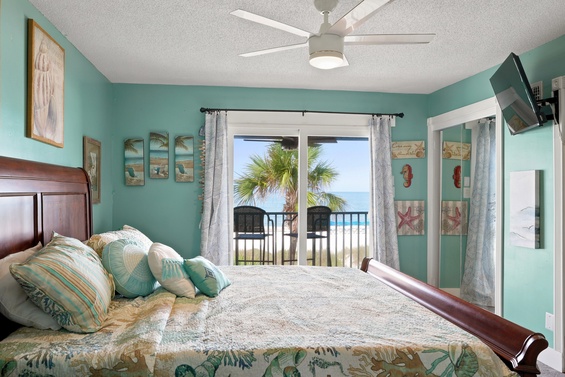 Drift off in this coastal bedroom, where turquoise walls and ocean breezes create your peaceful retreat. Wake to palm-framed views from your private balcony.