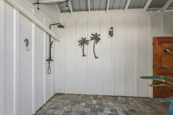 Step into your private outdoor shower—a bright, breezy space where you can rinse off in the open air surrounded by tropical charm and coastal ease.