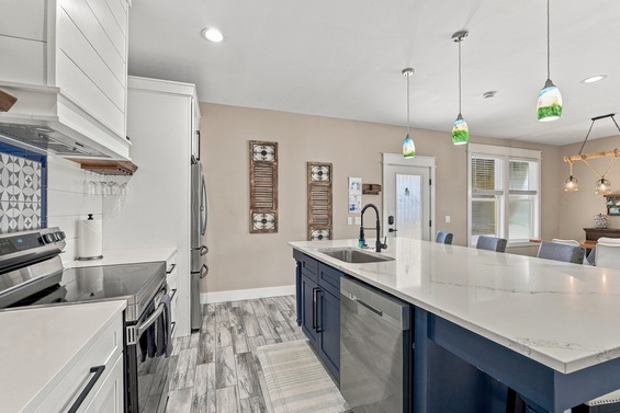 Bright, spacious kitchen with modern appliances and gleaming countertops. Open layout flows seamlessly into the dining area, perfect for gathering with loved ones.