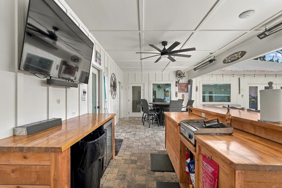 Gather, cook, and unwind in this open kitchen and dining space with warm wood counters and coastal charm overhead.