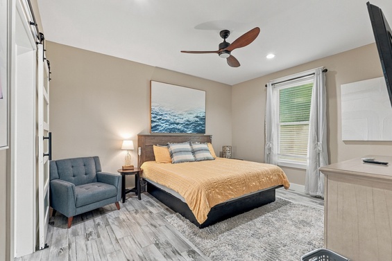 Relax in your bright, restful bedroom with plush bedding, a ceiling fan to keep cool, and coastal-inspired décor. Unwind in your cozy chair after a day of adventure.