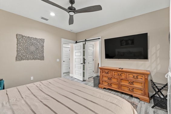 Sink into your plush bed and unwind in your peaceful bedroom, complete with a ceiling fan to keep you comfortable and a large TV for your favorite shows.