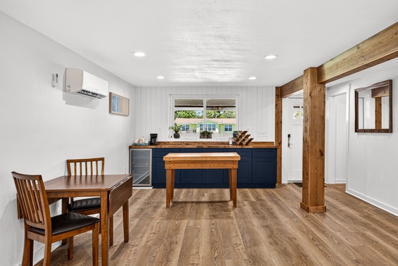Picture yourself preparing meals at the spacious wooden island with natural light streaming through the window, then gathering around the table for unforgettable moments in this stylish kitchen and dining space.