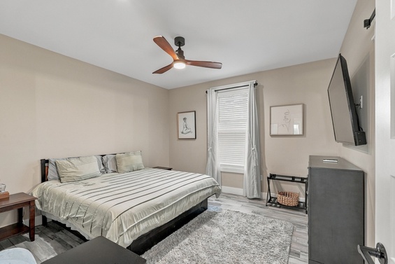 Unwind in your serene bedroom, where a gentle ceiling fan and plush bedding await to lull you into restful sleep.