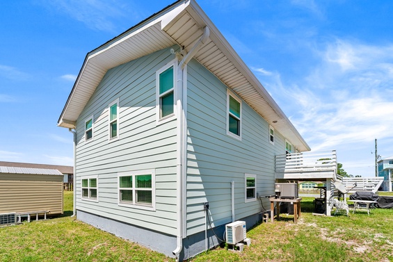 This charming two-story cottage features fresh coastal-inspired siding and a spacious layout, perfectly situated in a peaceful neighborhood setting.