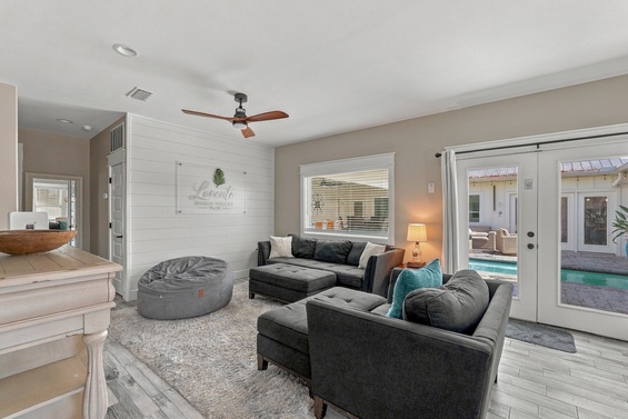 Sink into plush seating and let the natural light wash over you as the pool beckons just beyond your glass doors—a seamless indoor-outdoor retreat.
