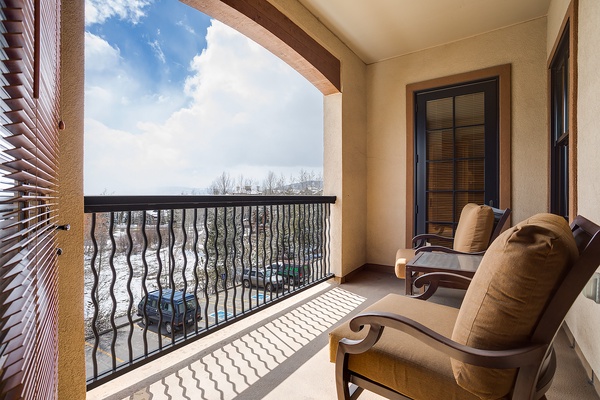 Step onto your private balcony and sink into plush seating while taking in peaceful lake views framed by natural beauty. Your perfect spot to unwind awaits.