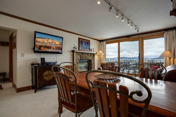 Gather around the handcrafted dining table with mountain views stretching beyond your windows. Your fireplace awaits cozy evenings, while the balcony invites fresh alpine air into your retreat.