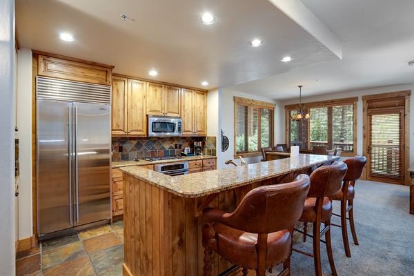 Step into your home-away-from-home kitchen, where granite countertops and warm wood cabinetry invite you to gather around the breakfast bar with family and friends.