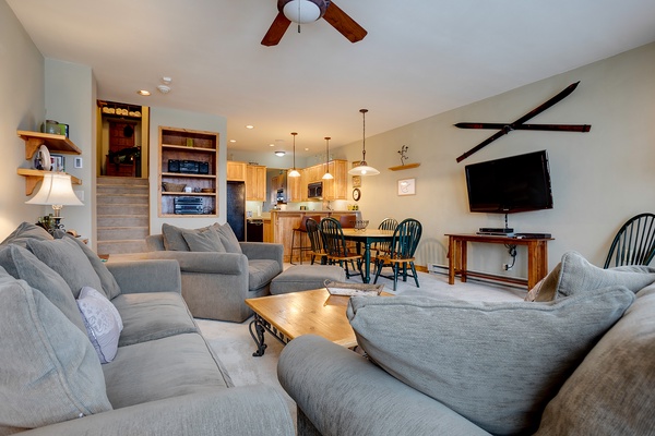 Unwind in your spacious living area with plush sofas, ceiling fans, a big-screen TV, and an open layout that flows into the fully-equipped kitchen and dining space—perfect for relaxing after a day of adventure.