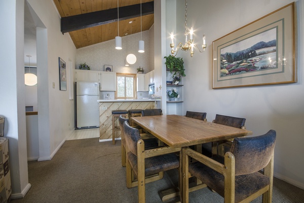Gather around your private dining table beneath soaring wood ceilings and elegant lighting, with a fully equipped kitchen at your fingertips for memorable meals together.