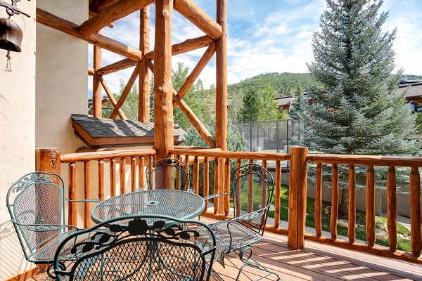 Step onto your private terrace and breathe in the crisp mountain air. This outdoor seating area invites you to unwind with morning coffee or evening wine, surrounded by evergreens and alpine views.