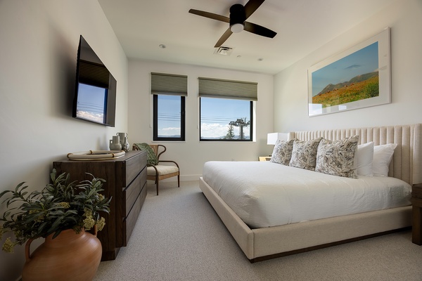 Slip into crisp white linens and let the gentle ceiling fan keep you cool as natural light pours through your windows. Wake refreshed in this thoughtfully appointed bedroom, your peaceful retreat after a day of exploring.