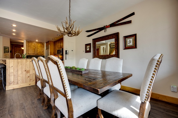Gather around this handsome rustic dining table, where an antler chandelier and mountain lodge decor set the stage for memorable meals with your group.