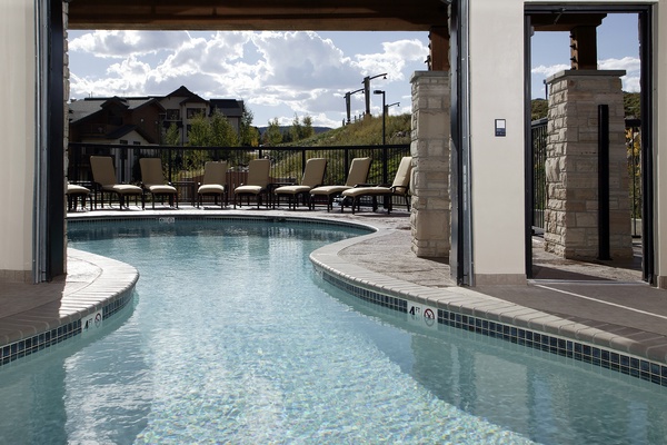 Your private poolside sanctuary awaits, with cushioned loungers and mountain views framing every moment. Step outside to bask in the sun, take a refreshing dip, or simply unwind under open skies.