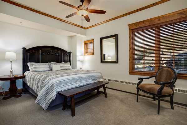 Sink into crisp linens and drift off under the gentle breeze of your ceiling fan, while warm wood accents and soft lighting wrap you in comfort.