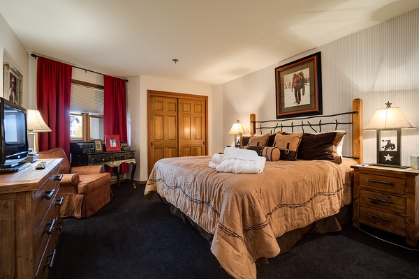 Sink into your king bed with Western charm—plush linens, rustic wood furniture, and warm lighting create your cozy mountain retreat after a day of adventure.