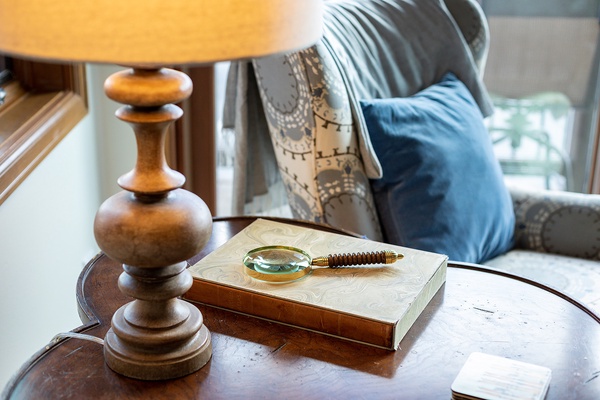 Curl up with your favorite book in this inviting seating area, where soft pillows and warm lamplight create the perfect reading nook for your stay.