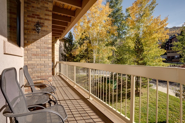 Step onto your private balcony and take in vibrant autumn foliage framing mountain views. Unwind in comfy lounge chairs while crisp air and golden leaves create the perfect escape.