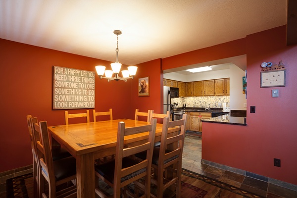 Gather around this welcoming dining table for family meals and laughter, with the fully-equipped kitchen just steps away to bring everyone together effortlessly.