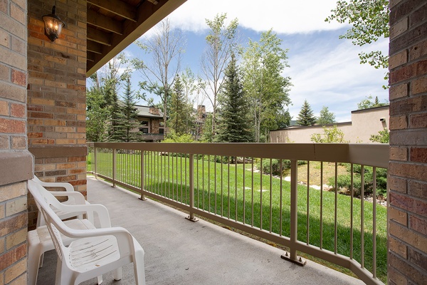 Unwind on your private balcony overlooking lush green lawns and mature trees—a perfect spot for morning coffee or evening relaxation in peaceful surroundings.