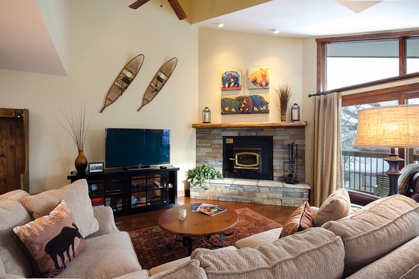 Sink into plush seating by your crackling fireplace, with mountain views framing your cozy retreat. Warm wood accents and thoughtful touches invite you to relax completely.
