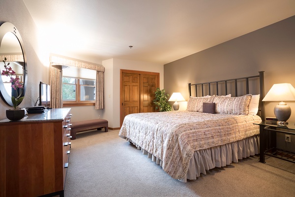 Unwind in your serene bedroom retreat, where soft linens and warm lighting invite peaceful rest after your mountain adventures.