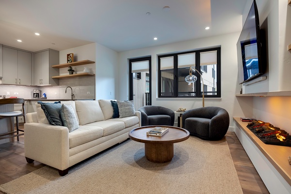 Step into your bright, open-concept retreat where modern design meets mountain comfort. Sink into plush seating by the fireplace, unwind with your favorite show, and enjoy effortless living in this stylish space.