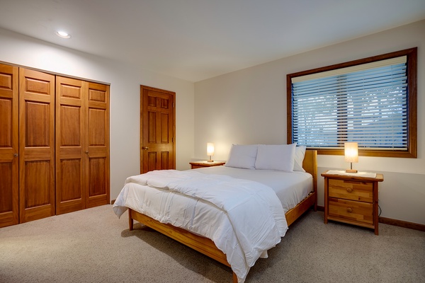 Slip into crisp linens and unwind in your serene bedroom, where warm wood tones and soft lighting create the perfect retreat after your mountain adventures.