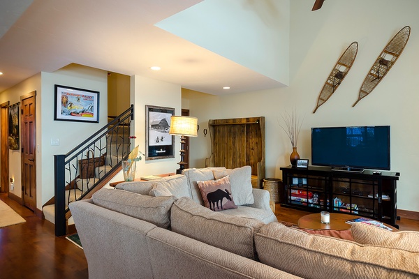Unwind in your spacious living area with vaulted ceilings, a cozy sectional, and your favorite shows on the large flat-screen. Perfect for relaxing after a day of adventure.