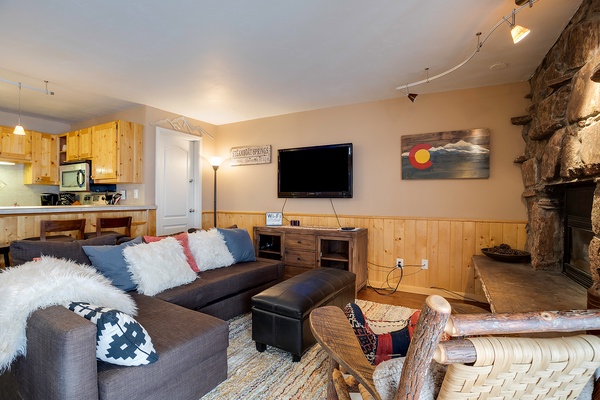 Unwind in your cozy living space with plush seating, a warm fireplace, and mountain-inspired touches that invite you to relax after a day of adventure.