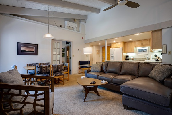 Settle into your inviting living space where a plush leather sectional awaits after adventurous days. Cook in the open kitchen, dine together, and unwind beneath soaring ceilings—your mountain retreat feels like home.