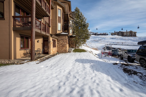 Alpine property located steps from ski slopes, with mountain gondola access and parking. Surrounded by winter scenery and neighboring lodges, offering an ideal ski vacation location.