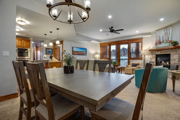Gather around this spacious dining table for memorable meals, with a cozy fireplace and mountain views creating the perfect backdrop for your getaway.