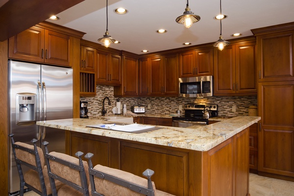 Picture yourself cooking your favorite meals in this beautifully appointed kitchen. Rich wood cabinetry, gleaming granite countertops, and modern stainless-steel appliances await your culinary adventures.