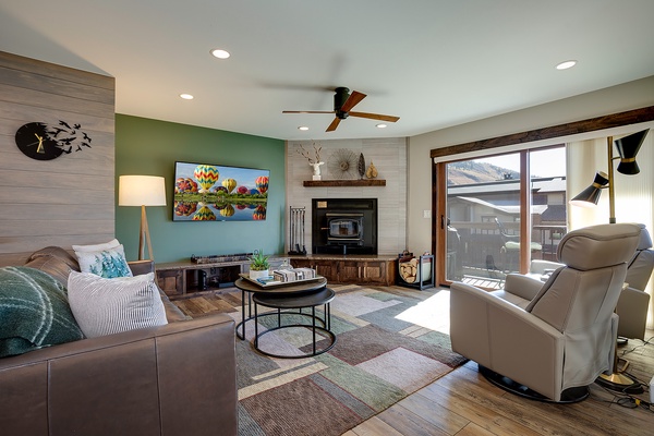 Settle into your cozy living room where natural light streams through the balcony doors, a warm fireplace awaits, and your favorite shows come alive on the flat-screen TV.