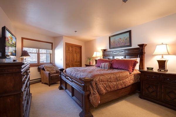 Sink into your cozy king bed surrounded by rich wood tones and soft lighting. Enjoy your favorite shows on the flat-screen TV and unwind in this welcoming retreat.