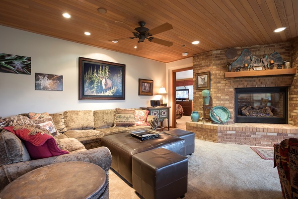 Sink into plush seating by your private fireplace, where rustic charm meets modern comfort. The warm wood ceiling and cozy décor create your perfect retreat after exploring nearby adventures.