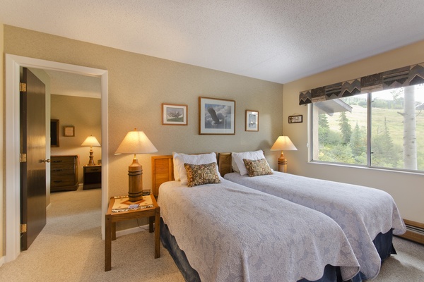 Relax in comfort with two plush beds dressed in soft linens. Morning light streams through your window, framing stunning mountain views that greet you each day.