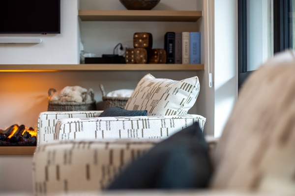 Sink into plush seating surrounded by warm textures and glowing ambient light—your cozy retreat awaits after a day of adventure.