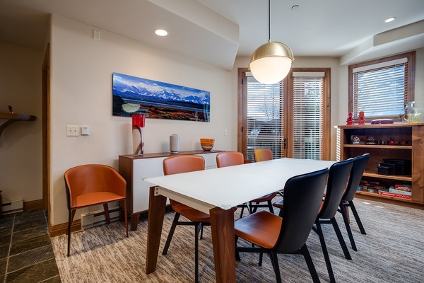 Gather around this stylish dining table with mountain views. The warm wood tones and modern chairs create the perfect spot for memorable meals together.
