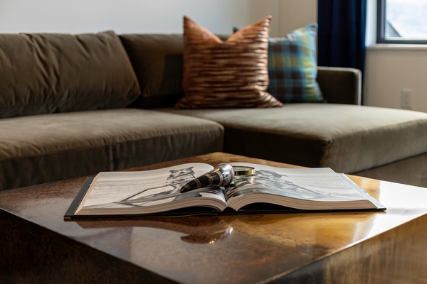 Settle into the plush sofa with a good book and soft natural light—your perfect spot to unwind after a day of exploring.