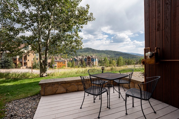 Scenic mountain backdrop surrounds this outdoor dining deck, offering a peaceful setting for morning coffee or al fresco meals during your stay.