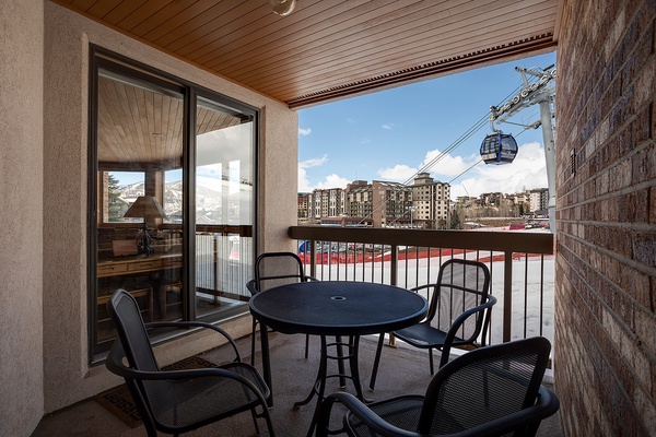 Your private balcony offers mountain views and gondola access, perfect for morning coffee or après-ski relaxation with seating for four.