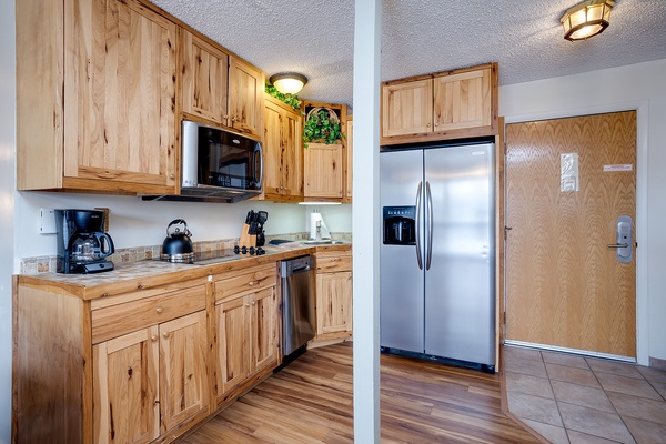Your kitchen awaits with rich wooden cabinetry, stainless steel appliances, and everything you need to whip up a home-cooked meal or brew your morning coffee.