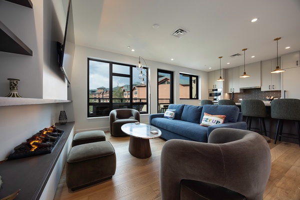 Unwind in this sleek living space, where modern comfort meets style. Plush seating, warm ambient lighting, and an open layout invite you to relax, while the connected kitchen makes entertaining effortless.