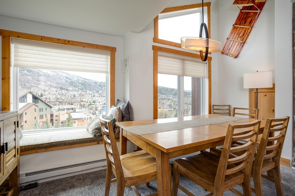 Picture yourself savoring morning coffee at this inviting dining table, surrounded by warm wood tones and natural light. The mountain views create a peaceful backdrop for your meals and conversations.